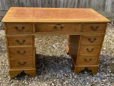 Light coloured mahogany twin pedestal writing desk of 9 drawers below tooled leather top 122L x 60 W