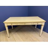 Cream and gilt painted writing table with 3 drawers and tapered reeded legs below a cream