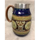 A Doulton ware commemorative jug with Royal blue borders and portrait and Medallions of King