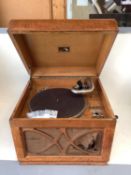 A vintage honey coloured oak case HMV wind up table top gramaphone, and a vintage sewing machine