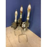 Two Homark draught beer engines and another part with ceramic handles decorated with hunting scenes,