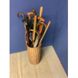 Quantity of C20th walking sticks, umbrellas, seats, in a wicker basket and brass and modern copper