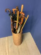 Quantity of C20th walking sticks, umbrellas, seats, in a wicker basket and brass and modern copper