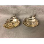 A pair of Victorian cast silver salts of recumbent figures holding oyster shell engraved Royal