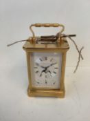 Brass cased carriage clock by Matthew Norman of London, no 1781, the dial with lunar apertures and 3