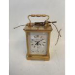 Brass cased carriage clock by Matthew Norman of London, no 1781, the dial with lunar apertures and 3