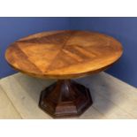 Circular octagonal pedestal table the geometric segmented top with a mahogany finish