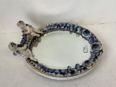 Continental porcelain framed small oval wall mirror with cherub finials, blue Sitzendorf marks (