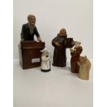 A pottery figurine of a standing monk 18 cm H and a teacher at his lectern 24 cm H forming the lid