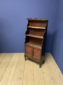 Small late Regency mahogany waterfall bookcase with wire netting and upholstery doors on turned feet