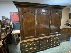 C18th oak hall cupboard of 3 panelled doors above a central cupboard flanked by 4 drawers with