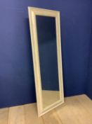 Wall mirror set within cream frame, 57 x 157cm overall