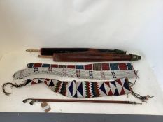 Three early C20th ethnic tribal bead work belts/sashes and two paper umbrellas, and 2 pipes