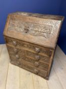 Heavily and entirely carved oak bureau with mask head handles 91 cm L x 108cm H. Condition general