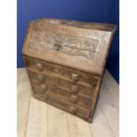 Heavily and entirely carved oak bureau with mask head handles 91 cm L x 108cm H. Condition general