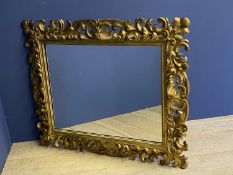 C19th giltwood oblong wall mirror, with a rococo scrolling frame, with shell finial, the plate is 67