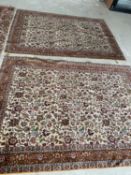 Pair cream ground rugs with all over floral motif and brown border, 218 x 153cm