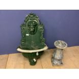 A green painted garden planter with lion finial to back plate, and a sundial, set in a ceramic stand