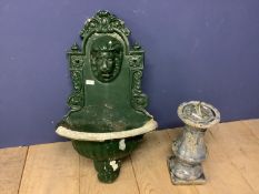 A green painted garden planter with lion finial to back plate, and a sundial, set in a ceramic stand
