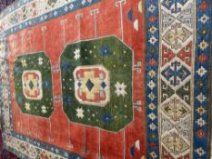 Large contemporary carpet, orange ground, two large green central medallions, with stylized borders,