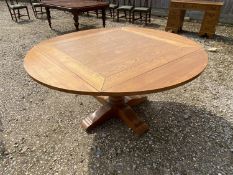 Honey coloured oak pedestal circular dining table with a drop side, hinged 152 dia x 76H