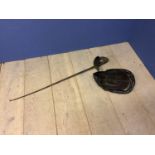 A fencing helmet and a fencing sword