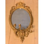 Regency oval wall mirror, set within a decorative gilt wood scrolling border, with shell scrolling