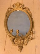 Regency oval wall mirror, set within a decorative gilt wood scrolling border, with shell scrolling