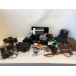 A quantity of cameras and binoculars to include Nikon, Canon, Nikon cam corder, Pocket Fujica,