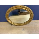 Oval wall mirror, set within a gilt wood frame decorated balls (some damage) 73 x 59cm and another