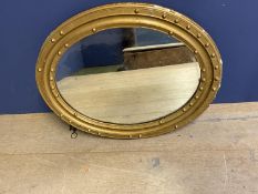 Oval wall mirror, set within a gilt wood frame decorated balls (some damage) 73 x 59cm and another