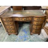 Mahogany serpentine front kneehole writing desk of 9 drawers beneath green leather top 115 cm L