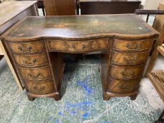 Mahogany serpentine front kneehole writing desk of 9 drawers beneath green leather top 115 cm L