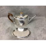 Silver tea pot and stand gross weight 28.4 ozt including handles. Both engraved with the Arms of the