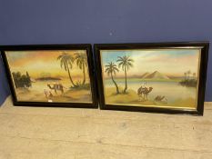 C20th Pair of oil paintings, middle eastern Arab tribesmen and camels in landscape 46.5 x 71 both