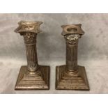 Two similar hallmarked silver weighted column candlesticks 15 cm H Condition tarnished and damage,