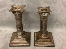 Two similar hallmarked silver weighted column candlesticks 15 cm H Condition tarnished and damage,