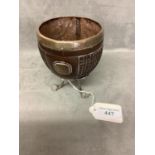 Carved coconut shell on a white metal support and a crested cartouche and rim 10 cm H