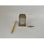 Miniature brass carriage clock with enamel dial and 2 subsidiary day and date dials 8 cm H