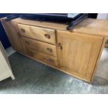 Good Quality 1960s Scandinavian style light hardwood low cabinet of 3 drawers flanked by cupboards