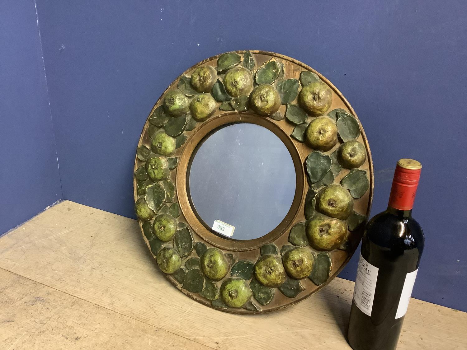 Early C20th Circular wall mirror, set within wooden frame, decorated with carved wood apples, 43cmd