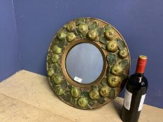 Early C20th Circular wall mirror, set within wooden frame, decorated with carved wood apples, 43cmd
