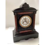 Victorian black slate chiming mantle clock, 43cm H. Condition: Losses and cracks to the case