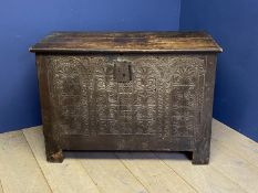 C18th heavy oak coffer the entire front intricately carved and with plain panelled sides. 113 cm L x