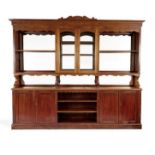 A late 19th century French mahogany and stained pine Baker's shop fitting 275cm wide, 34cm deep,