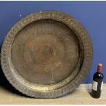 Large Copper tray, set within a deep scalloped edge rim, 72cm diam