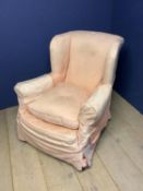Traditional mid C20th deep seated winged arm chair on brass castors in loose covers & feather