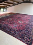 A good quality late C19th very large Sarouk rug, 731 x 450cm with crimson ground and all over floral