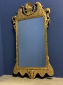Late C18th giltwood and gesso wall mirror with oblong shallow bevelled plate 75 x 46 with an