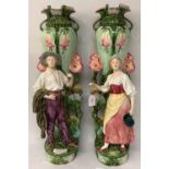 Pair of Art Nouveau period majolica tall vases, decorated with two figures, generally good